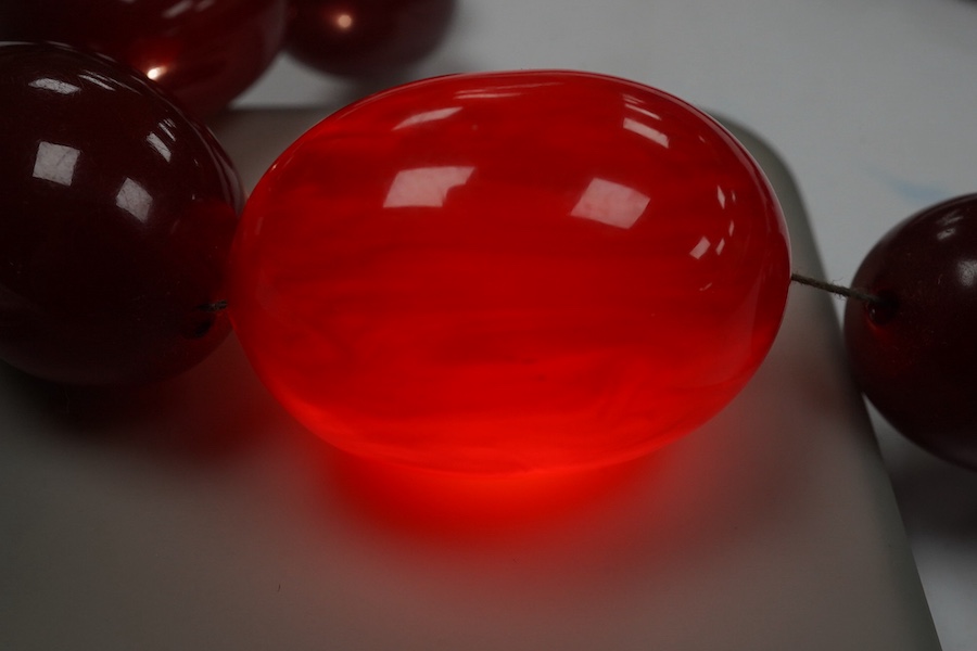 A single strand graduated oval simulated cherry amber necklace, 38cm, gross weight 47 grams. Condition - fair to good